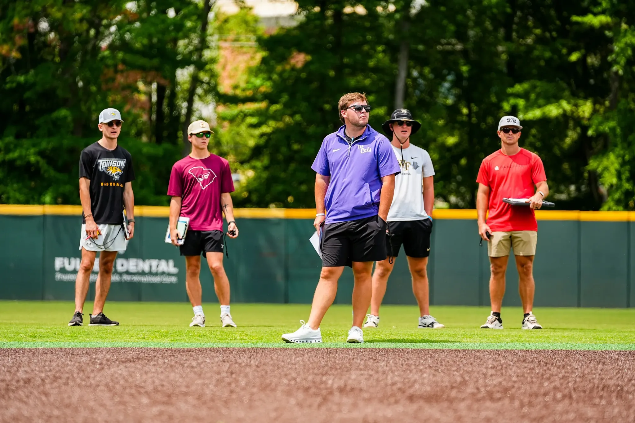College coaches with clipboards at the Carolina Classic